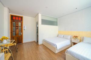 Postel nebo postele na pokoji v ubytování HOTEL NẮNG CHIỀU ĐÀ LẠT