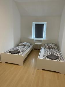two beds sitting next to each other in a room at City Flats Dortmund in Dortmund