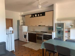 a kitchen with a table and a stove top oven at Mari-Mare Home in Rodi Garganico