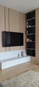 a living room with a flat screen tv on a wall at Avisi Living in Trebinje