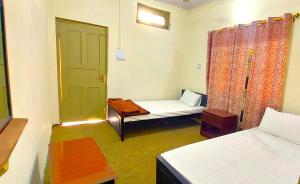 吉尔吉特ABC Hotel的一间设有床、门和桌子的房间