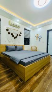 a bedroom with a large bed in a room at Hương Cảng Homestay in Hai Phong