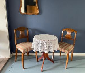 a table and two chairs with a table and a mirror at Vinter Bed & Breakfast in Sauvo