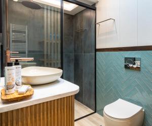a bathroom with a sink and a toilet at La Vista Azul - Sea View Apartment in Pláka +16 photos