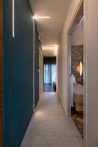 a hallway leading to a room with a bed at La Vista Azul - Sea View Apartment in Pláka