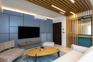 a living room with a couch and a table at La Vista Azul - Sea View Apartment in Pláka