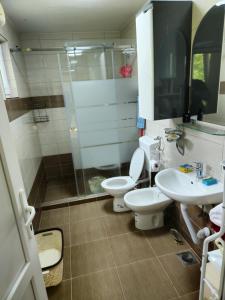 a bathroom with two toilets and a shower and a sink at Rooms Mery in Visoko +16 photos