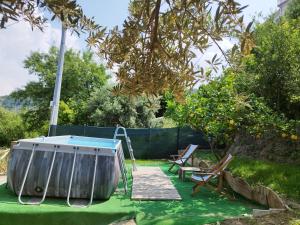 a garden with a swing and chairs on a lawn at La Terrazza in Gioiosa Marea