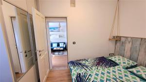 a small bedroom with a bed and a mirror at PALMA TRSAT with free private parking in Rijeka