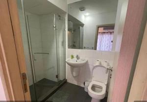 a bathroom with a toilet and a shower and a sink at JaneChill Guest House in Accra +18 photos
