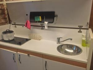 a kitchen counter with a sink and a sink at Kaboom Showroom & Guesthouse in Istanbul