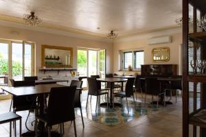 a dining room with tables and chairs at Hotel Villa Senator Mediterraneo in Tortora +50 photos