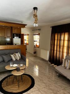 a living room with a couch and a table at Dionysus Sivota Center in Syvota