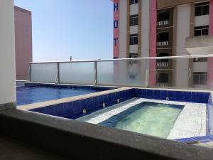 a swimming pool on the roof of a building at Apartment in Atacames in Atacames