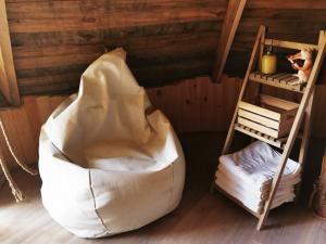 a large bean bag chair in a room with a ladder at La Bastide du Capelier - Cabane in Salernes