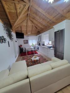 a living room with a couch and a kitchen at Xhumba Guesthouse 