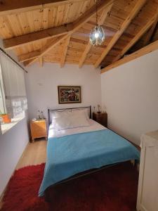 a bedroom with a bed in a room with wooden ceilings at Xhumba Guesthouse 