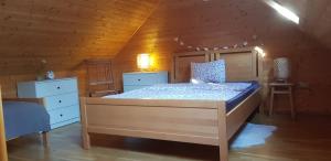 a bedroom with a bed in a wooden room at Mountain peaks Apartment with Sauna in Gozd Martuljek