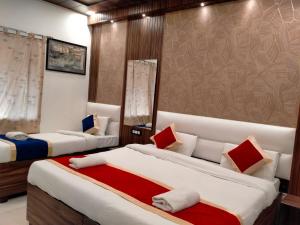 a bedroom with two beds and a couch at Hotel Sidhartha Walking Distance From TajMahal in Agra
