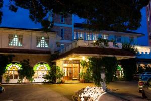 a building at night with a building at Protea Hotel by Marriott Dar es Salaam Courtyard in Dar es Salaam