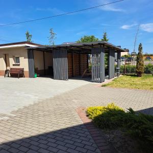 a building with a pavilion in front of it at Pokoje u Teresy in Rewa