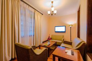 a hospital room with a table and chairs at Protea Hotel by Marriott Dar es Salaam Courtyard in Dar es Salaam