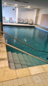 a swimming pool with chairs in a building at Appartement Le Montagnard in Les Déserts