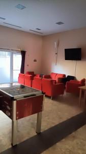 a living room with red couches and a flat screen tv at Appartement Le Montagnard in Les Déserts