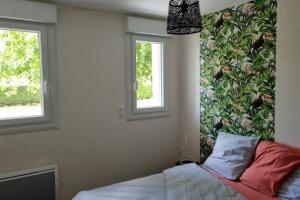 appartement en rez-de-jardin maison individuelle tesisinde bir odada yatak veya yataklar