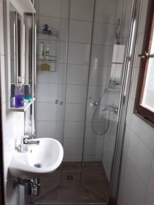 a white bathroom with a shower and a sink at Fachwerk-Romantik 2 an der Mosel in Treis-Karden