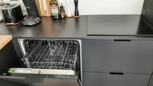 a dishwasher with a rack in it in a kitchen at Deluxe apartment suite with terrace in Antwerp