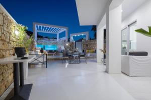 an open living room with a stone wall and white floors at Dion Villa Zakynthos Greece in Zakynthos Town