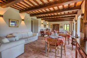 a living room with a couch and a table and chairs at Agriturismo Colli Martani in Massa Martana