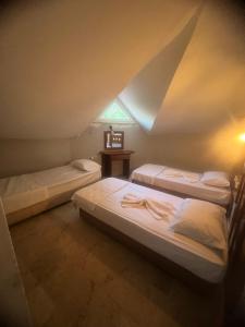 a room with three beds in a attic at EGE APART HOTEL in Marmaris