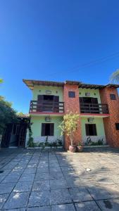 a red and yellow brick house with a patio at Pousada Cores Do Mar in Paraty