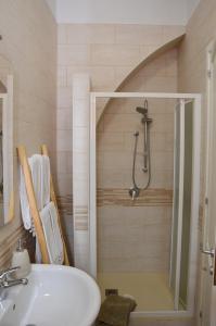 a bathroom with a shower and a sink at CaTó - Le vacanze come a casa tua in Carloforte +22 photos