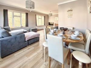 a living room with a table and a couch at Beach Haven - Uk42241 in Littlestone-on-Sea