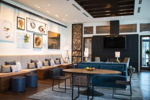 a lobby with a blue couch and a table at Renaissance Columbus Westerville-Polaris Hotel in Westerville