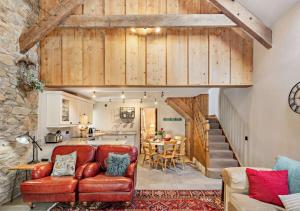 a living room with a couch and a kitchen at Stabal y Sarn in Sarn