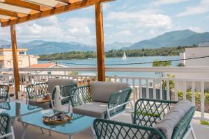 a balcony with chairs and a table and a view of the water at Villa Gioia in Tivat