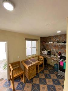 a kitchen with a table and a stove in it at Cozy apartment king bed ac downtown in Cozumel
