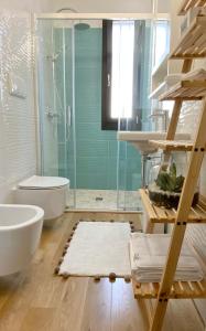 a bathroom with a shower and a toilet and a sink at La luna nel pozzo in Botrugno