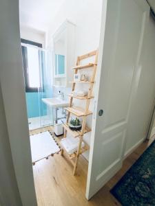 a bathroom with a ladder next to a sink at La luna nel pozzo in Botrugno