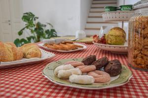 a table topped with plates of pastries and bread at La luna nel pozzo in Botrugno