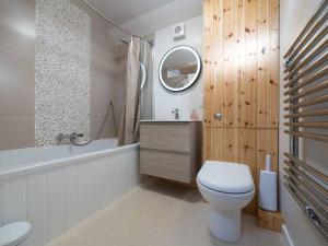 a bathroom with a toilet and a tub and a sink at Beachside chalet 3 Cormorant with access to beach in Cowes +32 photos