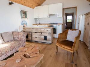 a living room with a couch and a table at Beachside chalet 3 Cormorant with access to beach in Cowes