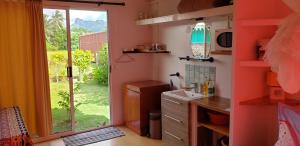 a kitchen with a door open to a garden at TEREVAA 2 in Fare