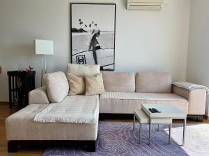 a living room with a couch and a coffee table at Sea View Apartment in Matulji