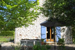 a building with an umbrella in front of it at Odiel & Gabrielle in Montchevrier