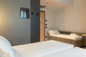 Postel nebo postele na pokoji v ubytování Hotel Leonessa